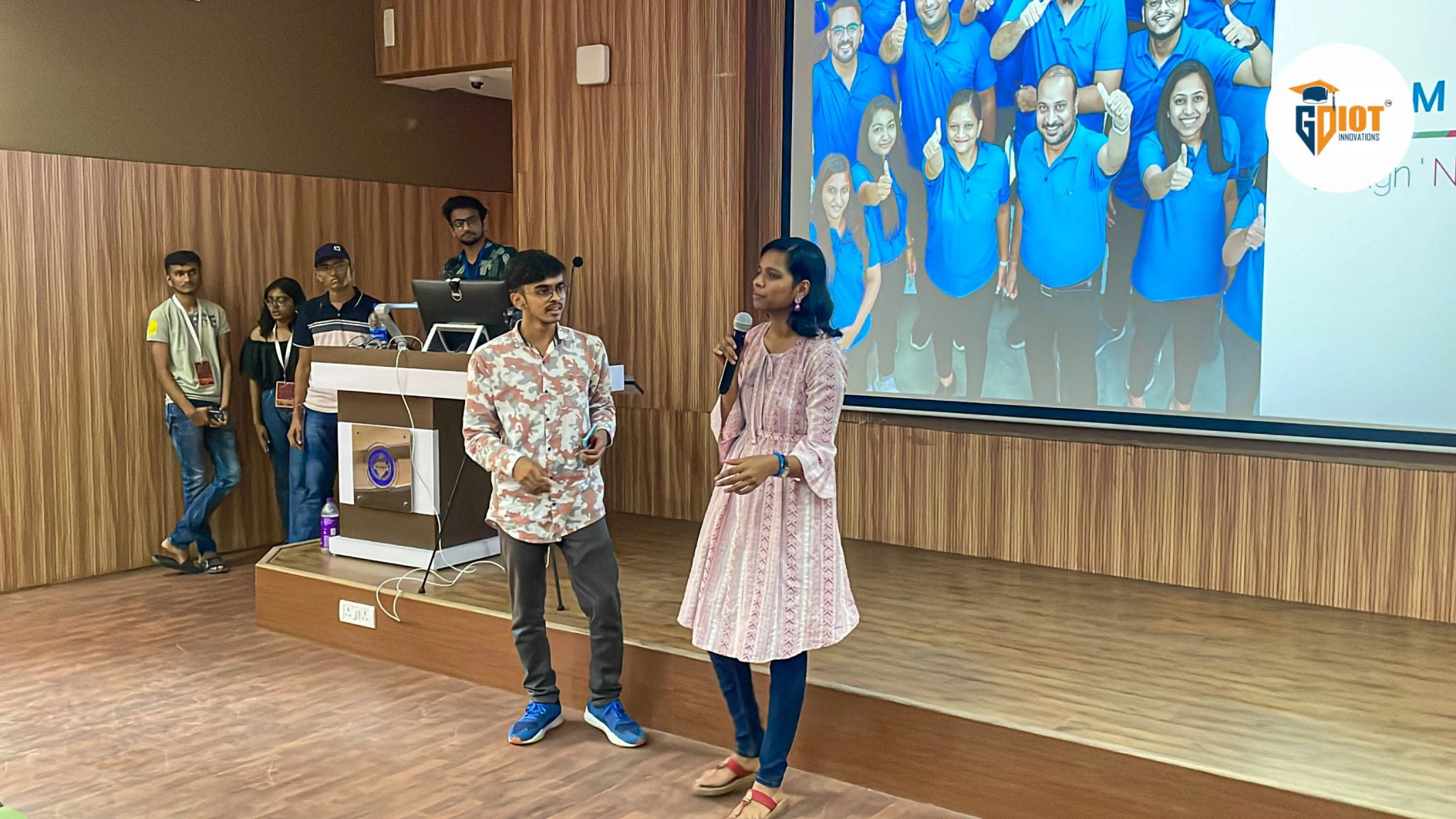 Latika Ray and Niraj presenting drone marketing strategy at Sell Out'23 in front of the Paradyes co-founders and a full auditorium